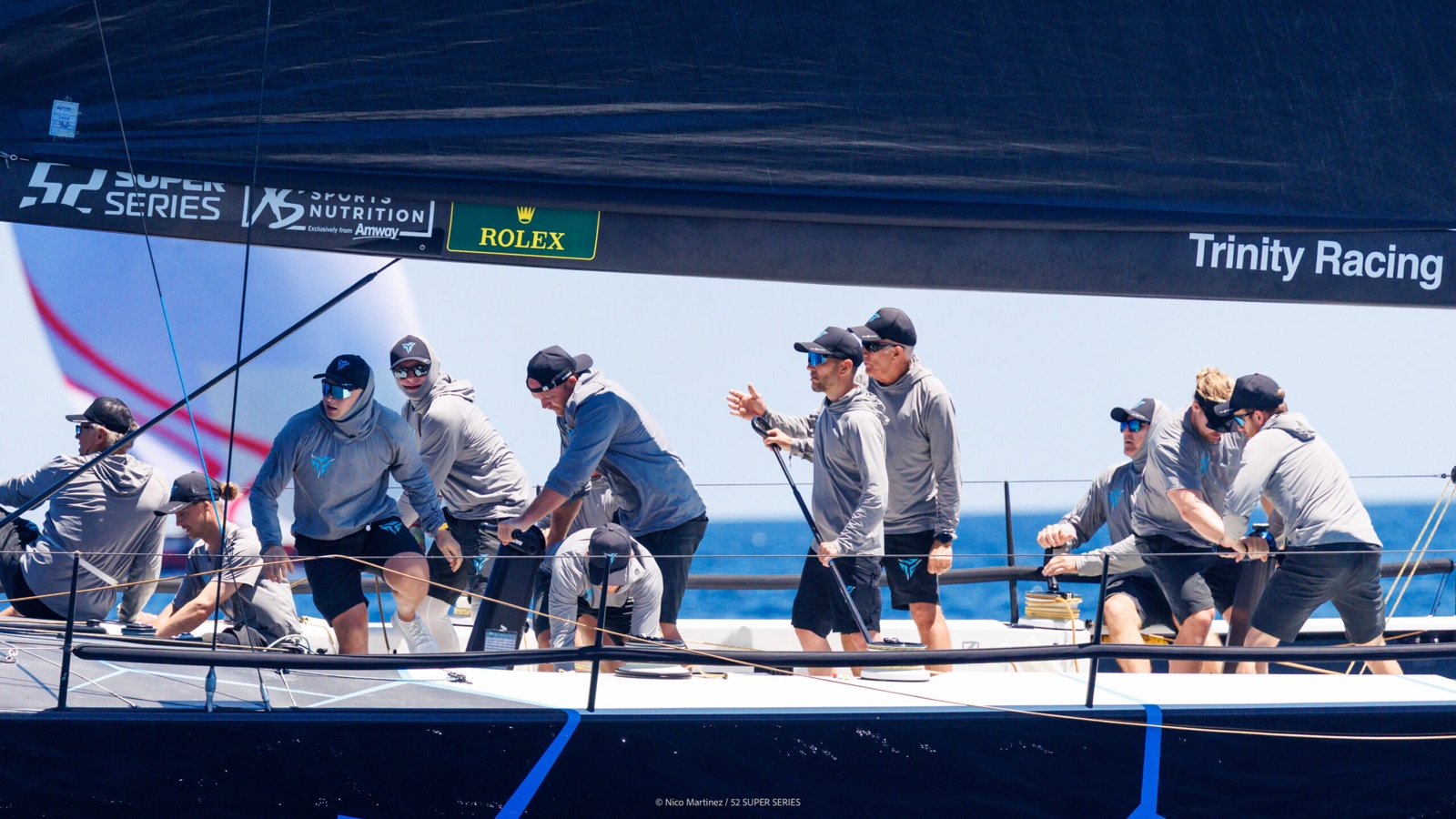 The Nordic Stars crew trimming and grinding mid-race, seen along the deck