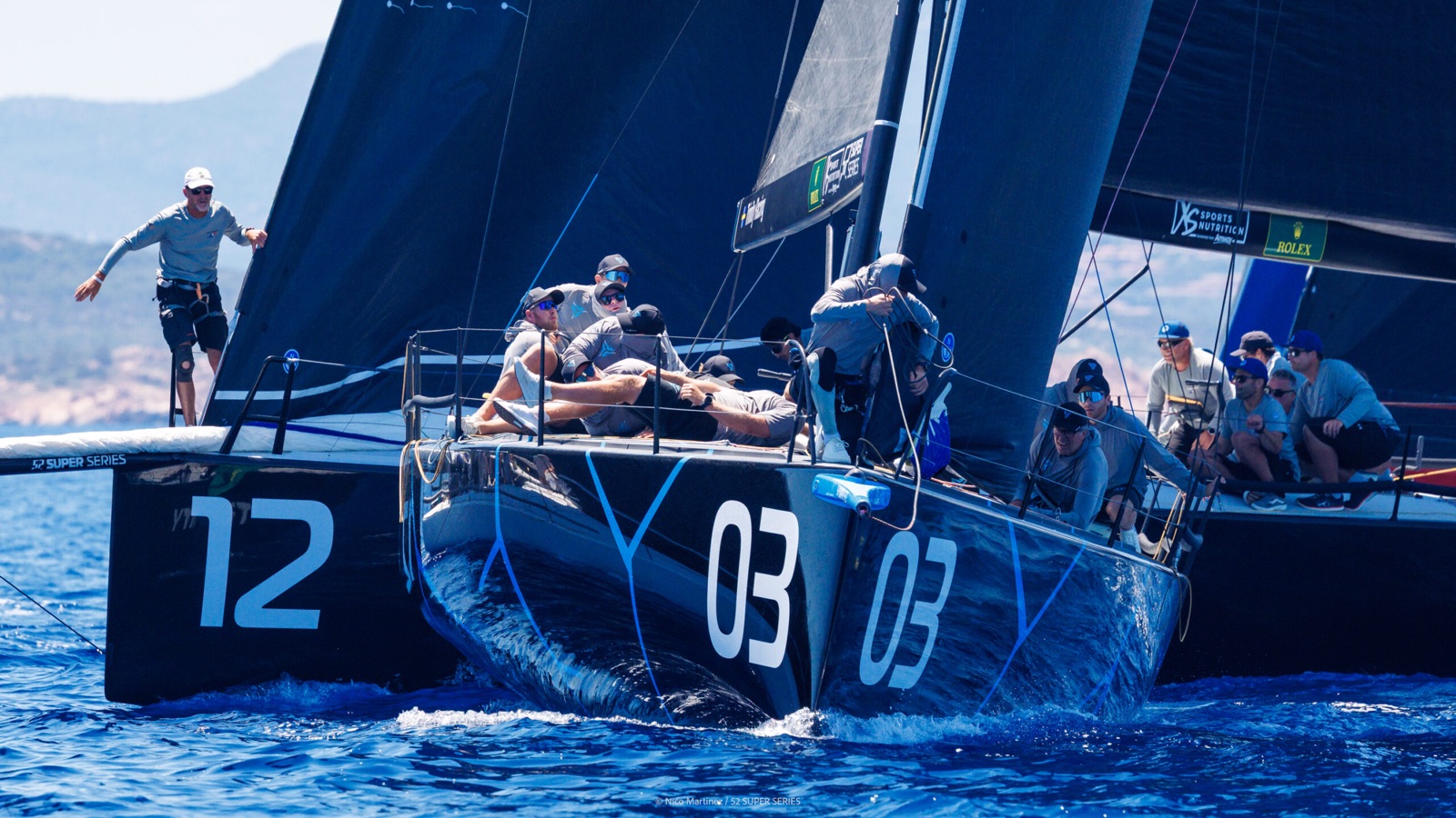 Nordic Stars ducking behind a rival in a tight pre-start